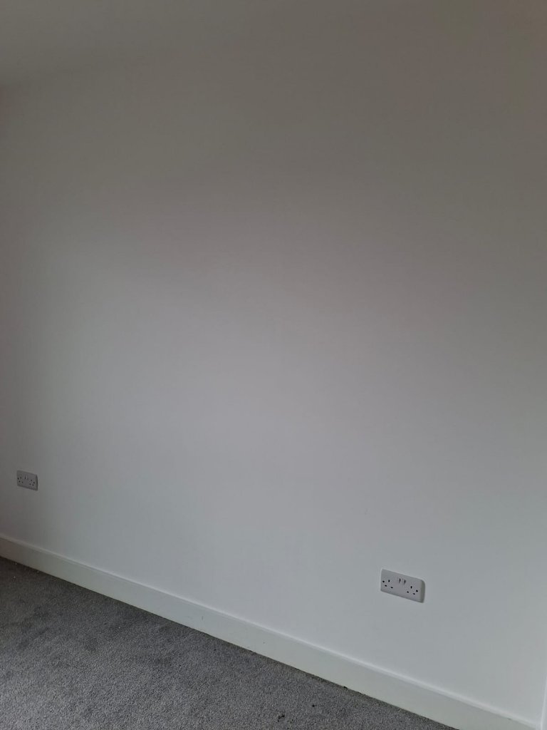 Freshly painted open-plan living room in a Peterborough city-centre rental flat
